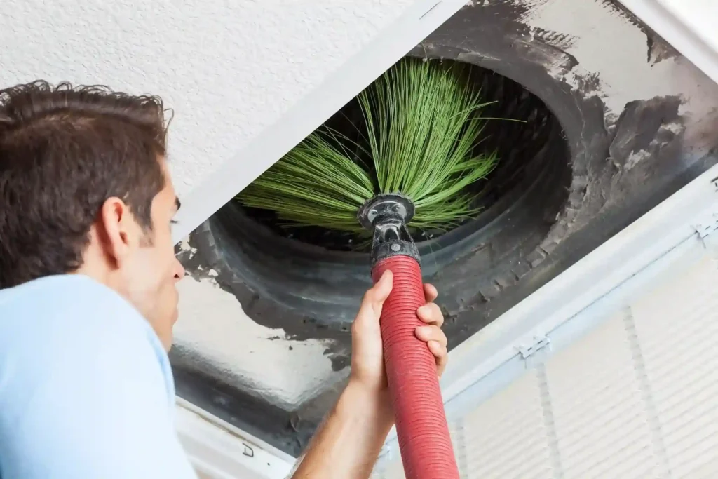 Duct Cleaning in Vernon Hills, IL 1 A technician cleaning a duct work by a rooter system brush