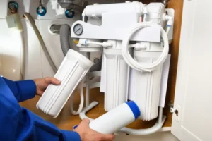 Water Filtration Services In Mundelein, IL 3 A technician installing a filtration system in air purifier